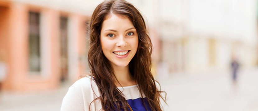 A young girl employee smiling and looking at the camera.